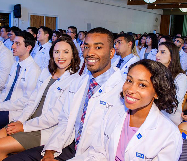 smiling at a white coat ceremony