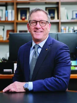 Dean Krebsbach is in his office having his annual photoshoot taken.