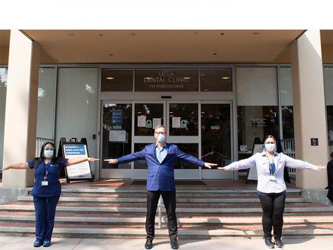 Mia King and Marcela Hamparsumian with Dean Krebsbach outside of the UCLA Dental Clinic entrance.